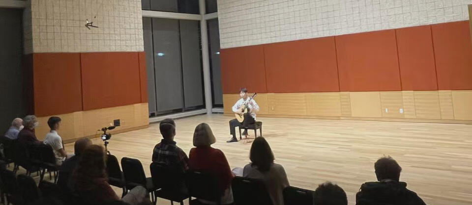 Jiujiu Wu performing a classical guitar at the Boston Guitar Fest 2022 Jiujiu Wu performing a classical guitar at the Boston Guitar Fest 2022